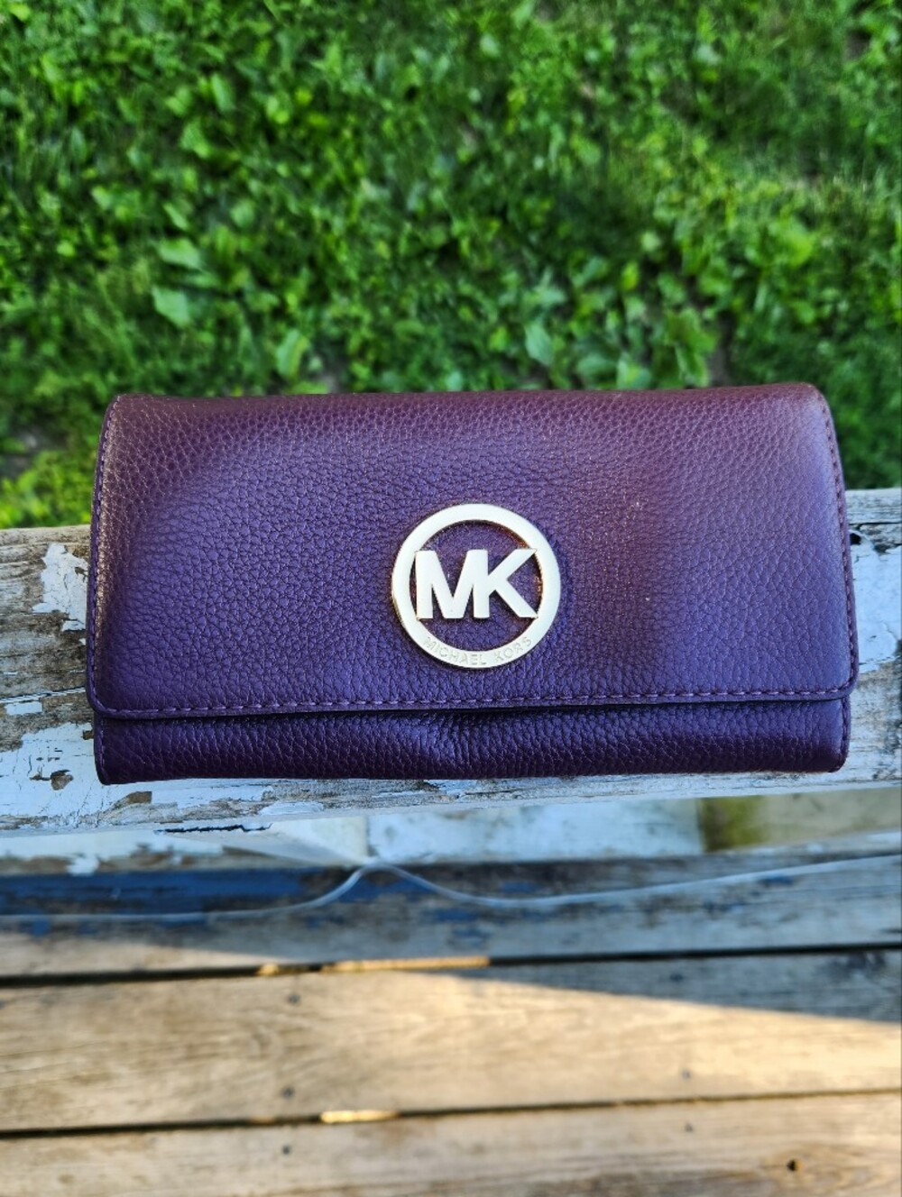 Michael Kors Fulton flap wallet textured plum leather prominent gold logo plaque